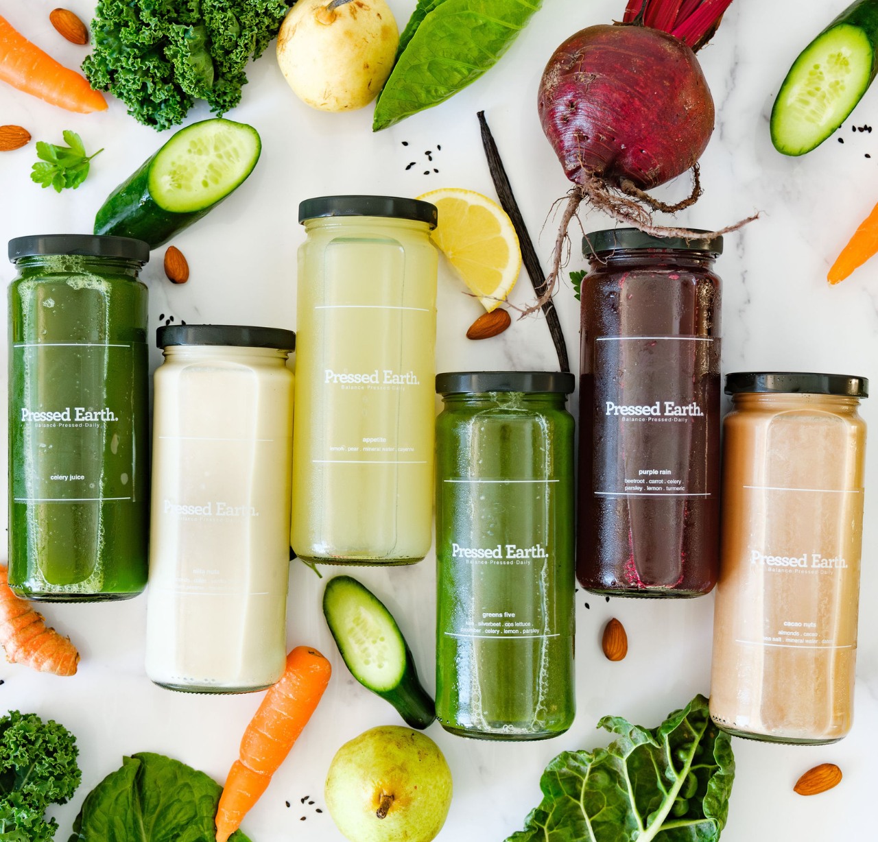 Pressed Earth low sugar juice cleanse selection of six cold-pressed juices in glass bottles Perth